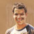 Pixelated static image of a person in a white shirt with dark shoulder accents against a solid brown background, appearing as an AOL Instant Messenger buddy icon.