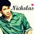 Pixelated image of a person with dark hair wearing a green patterned shirt, with partial text and a pink dot visible in the background.