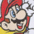 Pixelated character with red cap, blue eyes, black mustache, yellow shirt, and open mouth showing teeth.