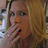 A pixelated image of a person with light brown hair covering their mouth, overlaid with the text 'KRISTY' in white block letters.