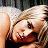 A pixelated image of a woman with blonde hair and a black top on the left, next to stylized text reading "Natasha Bedingfield" in black font on white background.