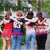 Group of five people standing outdoors with arms around each other, next to text reading 'bestfriends! h.m.c.k.' on a green background.