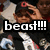 A person in a black cap with red logo adjusts the cap with one hand, wearing a black jacket over a white shirt with red accents, with 'beast!!!' text overlay.