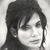 Black-and-white pixelated portrait of a person with long dark hair, closed eyes, and a neutral expression, cropped to show head and shoulders.