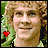 Pixelated image of a person with curly light brown hair and a red heart symbol on the left side, next to green text reading "OriginalIcons.com" on dark green background.