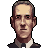 Pixelated portrait of a man with short dark hair, light skin, and a neutral expression wearing a dark suit jacket over a light shirt.