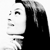 Pixelated grayscale profile of a person with long dark hair, neutral expression, and visible facial features including eyes, nose, and mouth.