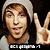 A person wearing a light gray beanie and matching shirt makes a peace sign with their right hand against a black background, with text below the image.