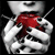 A person's hands hold a red apple with black seeds against a dark background, transitioning through motion blur effects.