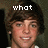 A pixelated image of a person with brown hair and a white shirt, showing text overlays that change across frames.