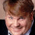 A static image shows a person with light brown hair and a dark suit, next to handwritten text reading 'Tommy', 'Like', and 'WINGIEZ' on white background.