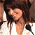 A contact sheet of two animated frames showing a person with long brown hair in a white top holding a microphone, next to green text reading "Original Icons .com" on a dark background.