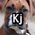 A four- of dog faces with overlaid text: 'Kj' on top-left, 'Is' on top-right, 'My' on bottom-left, and 'Buddy' on bottom-right