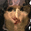 Two side-by-side pixelated faces with dark hair, one showing a smiling mouth and the other a neutral expression.
