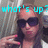 A person wearing dark sunglasses and a white top makes a peace sign with their right hand, with light blue text reading 'what's up?' above them.