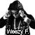 Pixelated grayscale image of a person wearing a hooded jacket and sunglasses with text "MEG F." at the bottom.
