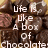 A static image of assorted chocolates with overlaid text reading "Life is like a box of chocolates going to get you'll never know what your" in white pixelated font.