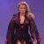 A pixelated image of a woman in a black dress with red accents standing against a purple background, next to green text reading "Original Icons .com" on dark green.