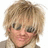 Pixelated close-up of a person with light brown hair, wearing dark sunglasses and a neutral expression against a white background.