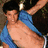 A pixelated image shows a shirtless person with dark hair and blue clothing being lifted by another figure, next to a light blue cube with white lines and text.