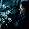 A sequence of frames showing a person in dark clothing with long hair, transitioning from full-body to extreme close-up on teeth and mouth.