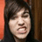 A pixelated image of a person with dark hair and a neutral expression, accompanied by blue text on black backgrounds.