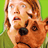 Pixelated static image of a cartoon character with brown hair and orange skin against a green background, featuring visible dithering and low-resolution rendering artifacts.