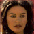 Pixelated close-up of a person with dark hair and closed eyes against a blurred background with warm tones.