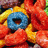 Pixelated image of colorful cereal loops with a blue ring-shaped piece, set against a bright blue background with green text.