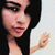 A pixelated animated icon shows a woman with long black hair, pink lips, and dark eyes in three sequential poses against a light background.