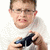 A person in a white shirt holds a dark game controller against a plain background, with subtle variations across four