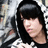 Pixelated image of a person with long black hair and bangs wearing dark clothing against a blurred background.