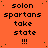 Orange background with black pixelated text reading 'solon spartans take state !!!' repeated in a pattern, with a gray rectangular area in the bottom-right corner