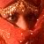 Pixelated close-up of a face with brown eyes and reddish-brown hair against a red background, showing visible pixelation and color blending.