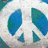 A split-screen icon with a peace symbol on top left, 'LOVE' text below it, and a small blue pixelated shape on light blue background.