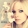 A static image shows a person holding white orchids with red centers near their face, with the word 'AVRIL' in blue text on the left side of the image.