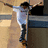 A person in a white shirt and dark pants stands with arms outstretched against a blurred background, with red text reading "Myjah Huston" on the right side.