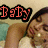 A person lies on a bed with eyes closed, wearing a white top and dark headband; text changes from 'Baby' to '&' to 'I' in red pixelated font.