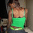 A person in a green tank top and dark pants stands with back turned, head tilted left to right across frames.