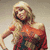 A pixelated image of a woman in an orange off-shoulder dress with black accents, posing against a light background.