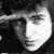 A grayscale pixelated image of a stylized face with a bright white area on the right side, dark background, and visible pixelation.