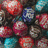 Pixelated image with blue background and white text, showing colorful rounded objects on the left side.