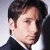 A 50x50 pixel animated contact sheet showing two frames of a David Duchovny icon with green text on the right side reading "Original Icons .com" against a dark background.