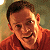 A pixelated image split into two sections: a person in an orange shirt on the left and green text reading 'Original Icons .com' on the right.