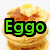 Stack of golden-brown pancakes with butter and syrup, topped with a yellow egg yolk, overlaid with pixelated text in green, orange, and blue.