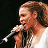 A pixelated contact sheet showing two frames of an animated icon featuring a person holding a microphone on the left and green text reading "Original Icons .com" on the right against a dark background.