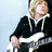 A person with light brown hair wearing a black hoodie with white drawstrings holds a white and silver electric guitar against a light blue background, with blue text on a yellow background reading "You'll always be my thunder. So bring or the rain... And bring on the thunder".