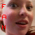A pixelated close-up of a person's face with red and white vertical text on the left side, showing slight mouth movement.