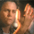 A pixelated image shows a person holding a glowing object near their face, with a dark background and warm color tones.