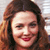 Pixelated close-up of a woman's face with long brown hair, red lipstick, and closed eyes against a light background.